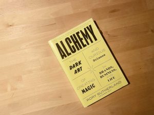 An image of the book, Alchemy on a wood surface.