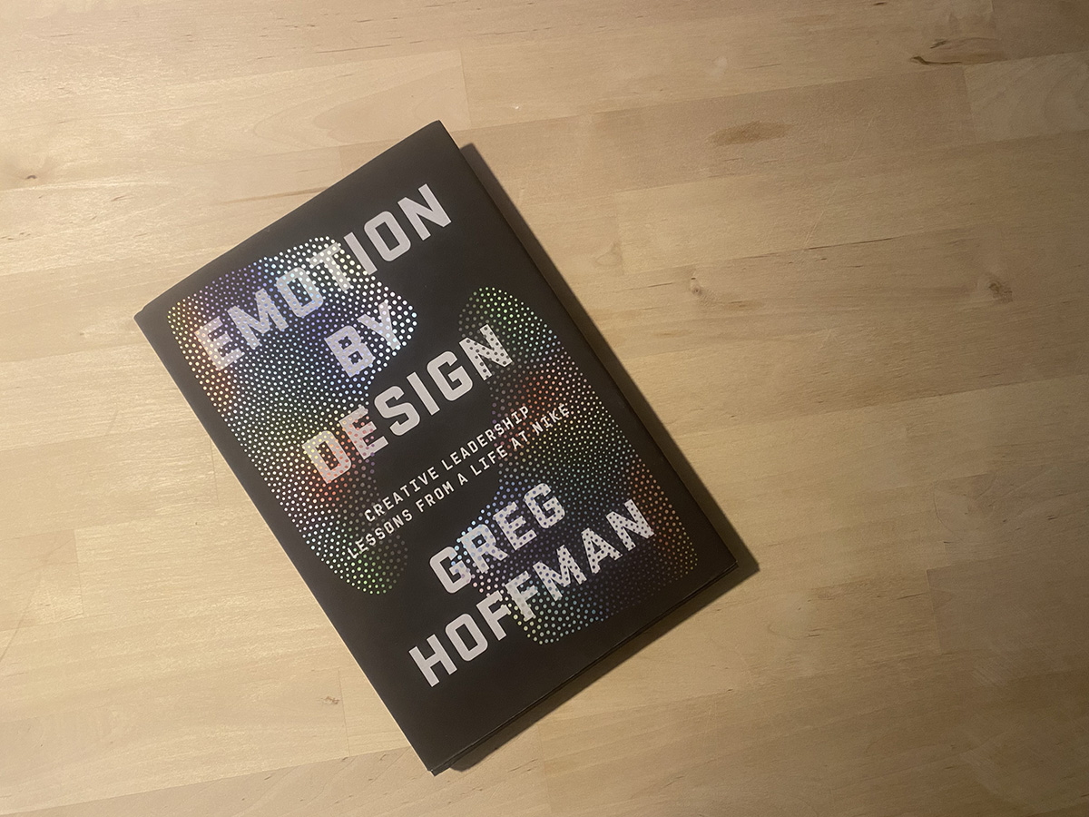 The book emotion by design lying flat on a wooden surface.